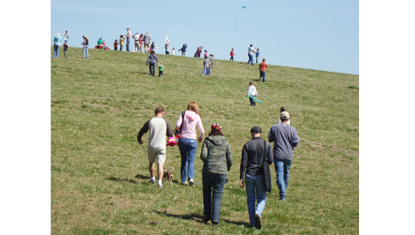 Families make their way up Hawks Ridge Hill behind FENCE for last year’s Go Fly A Kite Day. (photo submitted)
