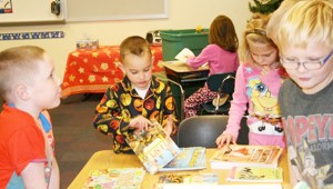 There’s something special about a brand-new book. First graders Daylon Bradley, Dakota Searcy, Evie Hill and Travis Green choose the perfect book for them. Volunteers Bailey and Elizabeth Nager had prepared them for the choice by reading and showing the great books to pick. 