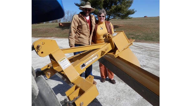 Joey Thompson and Julie Gordon with FENCE’s new grader. (photo submitted)