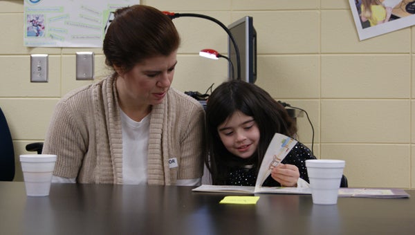 First-grader Jocie Jordan reads to her mother. First grade children enjoyed reading to their parents at O.P. Earle Elementary’s Books for Breakfast. During the event parents were given tips on how to help their child with reading at home. (photo submitted by Dawn Lynch)