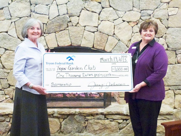 Wyndy Morehead of the Tryon Garden Club accepts a check from Sonja Laughter of Tryon Federal Bank for a premier sponsorship of “Four Seasons of Creativity Inspired by Pearson’s Falls” and “Learning to Grow…Growing to Learn.”  The 85th anniversary celebration of the garden club is Saturday, Aug. 10, from 6-9 p.m. at the Tryon Fine Arts Center. (photo submitted by Wyndy Morehead)