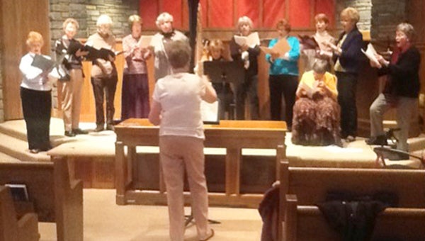 FMC Chorale members rehearsing at Tryon Presbyterian Church. From left to right: sopranos Fran Creasy, Elaine Jenkins, Jeanette Comer, Meryt Wilson, Elizabeth Gardner; altos Ellen Harvey Zipf, Janet Joens, Susie Mahnke, Nancy Walburn, Jeanette Shackelford and Mary Meyers (seated). Not pictured are sopranos Carole Bartol and Gwen Suesse.  (Photo by John Gardner.)