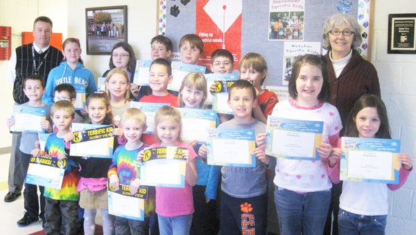 These students from Sunny View Elementary School were honored recently as “Terrific Kids.” The Tryon Kiwanis Club sponsors the program, which recognizes students from each classroom for their good citizenship and hard work for the month. Students received a certificate of honor, a pencil, and a bumper sticker that identifies their parents’ car as having a “Terrific Kid” in the family. March winners were: front row, left to right, Hunter Billings, Miya Jackson, Aiden Billings and Jayme Evans; second row, left to right, Eli Beaver, Garrett Moore, Annabelle Ruff, Daniel Searcy, Savannah Greene, Sebastian Potter, Dora Bailey and Rebecca Russell; back row, left to right, Principal Kevin Weis, Aries Cole, Riley Lawter, Gage Shelton, Logan Conner, Cameron Barnhart, Gavin Shelton and Lynn Montgomery (Kiwanis). (photo submitted by Angela Hall)