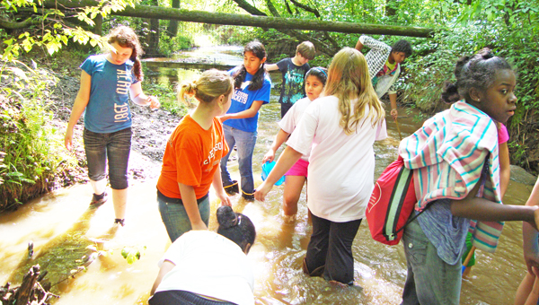 Fifth-graders from Polk Central enjoy Blockhouse Creek at FENCE as they explore the FENCE property. (photo submitted)