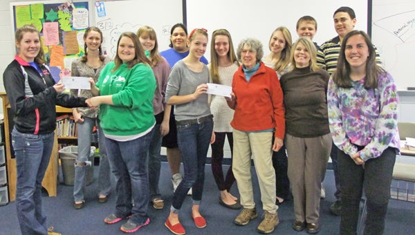 On Tuesday, March 12, the Polk County High School (PCHS) Humane Society Club awarded two checks for $200 each to the Foothills Humane Society (FHS) shelter to pay for medicine to cure two of their current heartworm positive dogs: Goodie and Francine. This money was raised during a very successful fundraiser, for which all funds were donated by Polk County High School students. The Humane Society club is now the official sponsor for Foothills’ heartworm positive dogs, about 44 percent of the animals overall. The main problem for a heartworm positive dog is that adoption may be difficult until they are cured and the medicine is very expensive, around $200 per dog. Gillian Westmore, sponsor of the club, said, “This fundraiser was so successful, we will begin a new one for the next dog very soon.” Club president, Juliet Taft, also said that “supporting the heart worm positive dogs has given our club a focus, as well as just our volunteering and providing services.” The active sponsorship of these dogs provides money for the medicine, educates the student body on the issue of heartworms, and gives the high school club a definite mission. (photo submitted by Gillian Westmore)