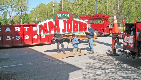 On the morning of April 22,  Eckstein Signs of Spartanburg were unloading and unpacking the new Papa John’s sign with a huge crane to put it in place. Papa John’s plans to open soon at the former Blockbuster buidling along East Rutherford St. in Landrum. (photo submitted by Anne Regan) 