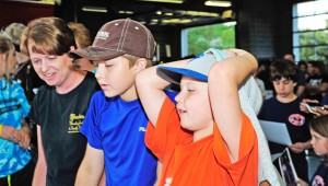 Sherry Rogers (left), Issac Medford (middle) and Jacob Medford (right) get autographs from “Moonshiners” stars.