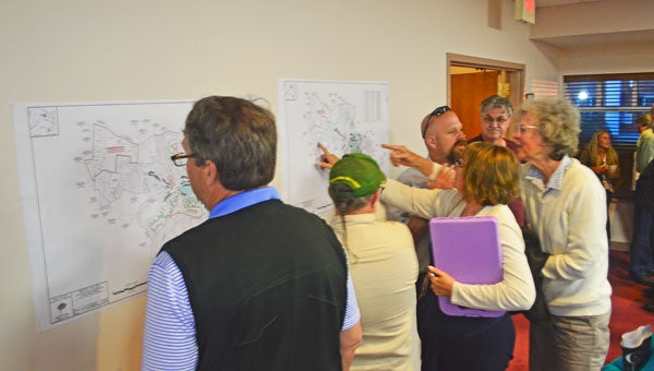 Interested citizens review maps showing the various zoning specifics of the Tryon Equestrian Properties development. (photo by Samantha Hurst)
