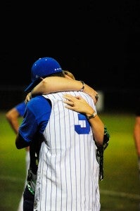 Polk center fielder Dylan Turner gets an understanding hug after the game.  