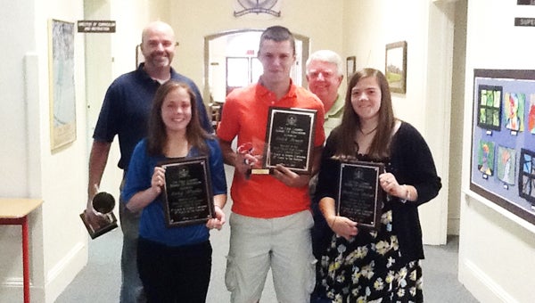 The Polk County Board of Education recognized the Polk County High School land judging team for their achievements Monday, May 16. The team earned eighth place in the nation on their recent trip to finals in Oklahoma City. Pictured are PCHS Agriculture Teacher Chauncey Barber and former Agriculture Teacher Richard Smith (back row) and students Caley Modlin, Caleb Brown and Mackenzie McCool.  A fourth team member Elena Preston is not pictured. (photo submitted by Aaron Greene, Polk County Schools) 