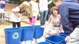 Student Malynne Petoia teaches elementary students how to sort recyclables. (photo submitted)