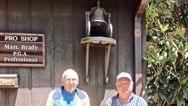 Fred Edwards Sr. and Fred Edwards Jr., with the caddy bell. (photo by Kiesa Kay)