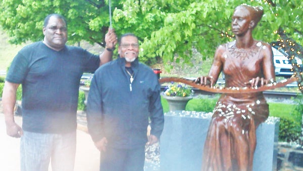 The Town of Tryon had a special visitor recently when Daddy O, actress Queen Latifah's father came to visit town commissioner Roy Miller's family. Pictured is Roy's brother Tony Miller (at left) with Daddy O in front of the town's Nina Simone statue located downtown. (photo by Roy Miller)