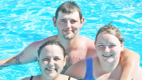 Gibson Park Pool opens to the public tomorrow, Saturday, June 8. Pool fees will remain the same this year, including for pool passes and swimming lessons. Pool hours are Tuesday - Saturday noon to 5 p.m. and Sunday, 1 - 5 p.m. Pictured are Randy Long, Josie Day and Samantha Long at the pool open house held last Saturday, June 1. (photo by Virginia Walker)