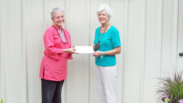 Tryon Presbyterian Church Women generously donated $1,000 of the proceeds from their recent Strawberry Social to Thermal Belt Outreach Ministry (Outreach). These funds will be used to help Outreach further its mission to provide compassionate assistance to Polk County residents who are unable to meet their basic life needs. Pictured at left is Carol Newton, executive director of Outreach.  At right is Jeanie Daniel, a member of the Tryon Presbyterian Women. (photo submitted by Wendy Thomas) 