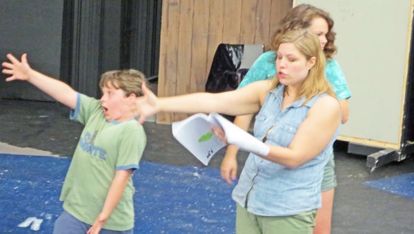 Director Jenna Tamisiea puts Augustus Gloop (John Henry Tennant) through his paces in an early rehearsal for “Willy Wonka,” this year’s Tryon Little Theater/ Tryon Youth Center Summer Youth Production. “I eat more!” Augustus roars as the audience becomes acquainted with his voracious eating habits. “Willy Wonka” is based on Roald Dahl’s book, “Charlie and the Chocolate Factory,” and although many have seen several different versions of the movie based on the book, this production is going to be “different from anything you’ve ever seen,” according to the director. The show runs July 18 – 21 at the Tryon Fine Arts Center. (photo Monica Jones)
