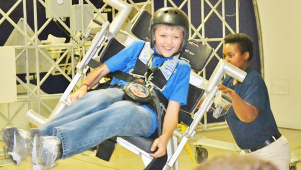 Fifth grader Liam Daniels of Tryon sitting in the astronaut simulator at Space Camp in Huntsville, Ala.. (photo by Tracey Daniels.)