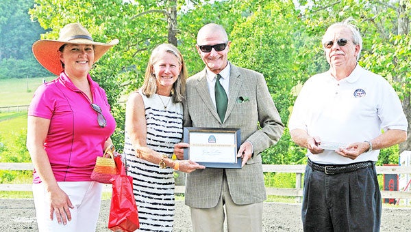 Town of Tryon Mayor Allan Peoples, far right, presents the key to the city to George Morris, center, along with TR&HC Events Executive Director Laura Weicker (far left) and President Nancy Wilson. See full story on page 6. (photo submitted by Laura Weicker)