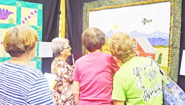 Quilting pals Martha Zglinicki, Barbara Lanning, Karen Lanning and Ellen McDonald marvel over the detail of Linda S. Bennett’s “My Blue Heaven” quilt at the Landrum Quilters biennial quilt show held Thursday, June 13-Saturday, June 15 at Landrum Middle School. “My Blue Heaven” was one of 150 entries for the Viewer’s Choice competition. Watch the Bulletin next week for results of the competition. You can also see more photos from the show at www.tryondailybulletin.com or by visiting us on facebook. (photo by Samantha Hurst)