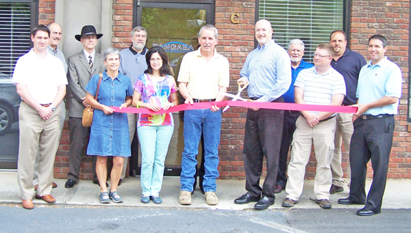 The Chamber of Commerce held a ribbon cutting ceremony recently to officially welcome Pangaea to their new location at 75 S. Trade St in Tryon. Staff, Pangaea board members, Chamber board members and support staff from TGA Solutions, who help Pangaea with network infrastructure were at the event. Pictured are Matt Chandler, Joe Crowder, Blake Smyth, Kathy Toomey of New View Realty, Jim Edwards, Carolyn Whitehead, office administrator, Stu Davidson Ops. Director, Ron Walters, Exec. Director, Thomas Glover of TGA, Jim McBurnett, Bruce Roberson and Ethan Waldman of Tryon Federal Bank. Pangaea internet provides high speed fiber optic internet service to four markets segments: education, government, healthcare, and commercial customers along their fiber route, more information can be found at www.pangaea.us. (photo submitted by Janet Sciacca)
