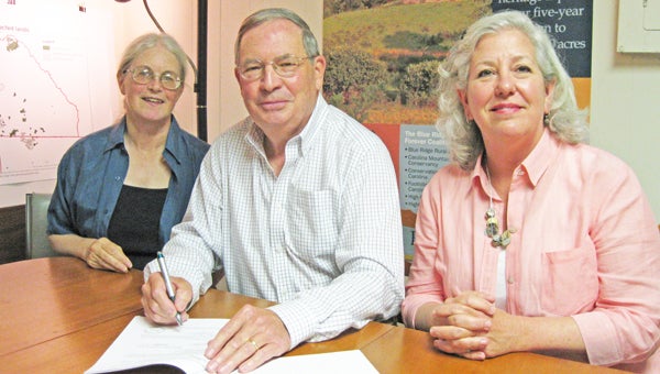 From left to right: Elizabeth Lamb (PAC president), Phil Burrus (Hunting Country Property Owners Association president) and Mary Walter (PAC executive director) at the closing of the Hunting Country POA conservation easement, protecting 2-acres of land in the Hunting Country. (photo by Pam Torlina)