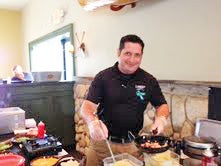 Jason Cole at Larkin’s Carolina Grill kicks off the weeklong Dining Out for Hospice event on Sunday, July 14, as he serves up made-to-order omelets for hungry patrons. (photo submitted by Marsha Van Hecke) 