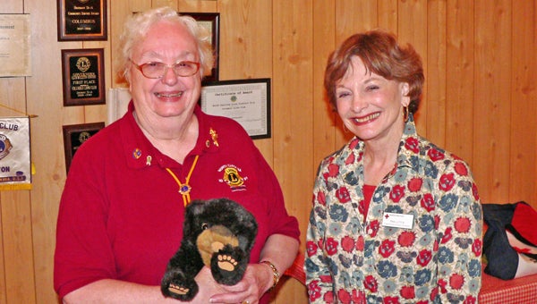 Columbus Lions President Fran Goodwin holds Scrubby Bear puppet after awarding a Columbus Lions Roar to speaker Pan Little. Little discussed American Red Cross Disaster Preparedness. (photo submitted by Garland Goodwin)