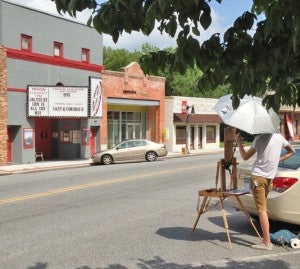 Greg Carr painting on Trade St. in Tryon. (photo submitted by Kim Nelson)