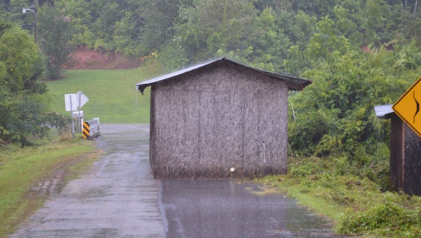 Rainwater flooding property pushed this shed into the road on Hicks McAbee off Hwy. 9 in Mill Spring over the weekend. See more photos of rain damage in the area at www.tryondailybulletin.com. (photo by Leah Justice)