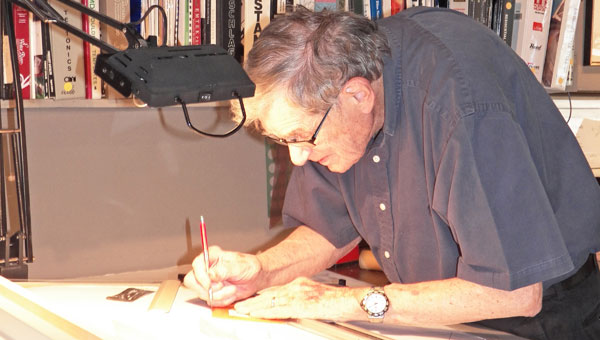 Holland Brady works at the drafting table in his office in downtown Tryon in 2012. Brady, then at 87, still came to work most every day. He passed away on June 20, 2013. (photo by Betty Ramsey)