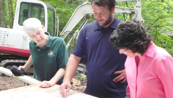 Carol Meeske, Tryon Garden Club committee chair, general contractor Austin Edwards and Elizabeth Nager, Polk County Community Foundation, look over plans for the new green restrooms. (photo submitted)