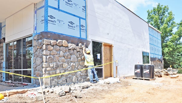A crew member constructs a rock facing to the new patient wing of St. Luke’s Hospital. The 15,000-square-foot addition is set to be completed in December. (photos submitted by Kathy Woodham)