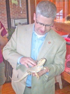 Congressman Patrick McHenry pets Spike, the bearded dragon at the FENCE animal exhibit. (photo submitted by Carrie Knox)