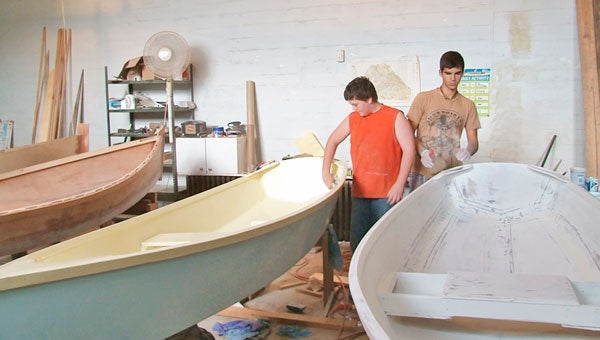 Noah Horshim and Larry Dyer work on their individual boats during Don Rausch’s workshop at the Mill Spring Ag Center. (photo by Kirk Gollwitzer)