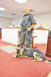 Polk County K9 officer Ronnie Russell introduced new K9 Ike to county commissioners during a meeting held Sept. 9. Commissioners and the audience asked questions about the new dog, a little over a 1-year-old German Shepherd. (photo by Leah Justice)