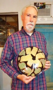 Claude Graves shows off a platter he has donated for a lucky drawing winner during the Bowl for Kids Sake event this Saturday. (photo submitted) 