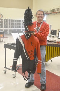 Barry Bridwell, director of bands at Landrum High School shows off Cardinal’s new Red and Black uniforms. (photo by Kiesa Kay).