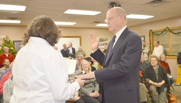 Newly elected Tryon Mayor Jim Wright was sworn into office on Tuesday, Dec. 17, in front of a standing room only audience. Tryon Town Clerk Susan Bell swore Wright into office, as well as newly elected commissioners Bill Ingham and Happy McLeod. (photo by Leah Justice)
