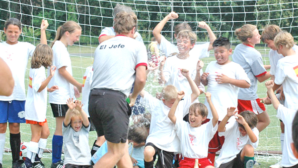 The 10th Annual Kirby Cup returns June 24-28, 2014 at Harmon Field in Tryon. Each year the winning team gets a traditional champagne shower, from camp director George Alley. (photo submitted by George Alley)
