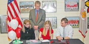 Lori and Todd Walter, left, look on as their daughter, Elizabeth, signs with Newberry College. Also pictured is LHS coach Jeremy Darby.