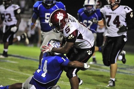Polk tumbles to Asheville 49 - 28. (Asheville is a 3A team-- Polk is 2A). Polk's Dequan Gary is taking down Asheville ball carrier Reggie Battle. (Photo by Mark Schmerling)