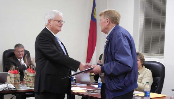 Cowan receives a plaque for his years of service from Chairman Geoffrey Tennant at the Polk County Board of Education meeting on Dec. 8. (Photo by Alissa Fiorillo)