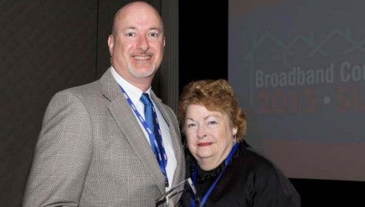 PANGAEA Internet Executive Director Ron Walters receives the 2015 Cornerstone Award from Jane Patterson, president, The View Forward – Go Forward, at the Broadband Communities Summit in Austin, Texas. (Photo by Rachel Ellner for Broadband Communities Magazine)