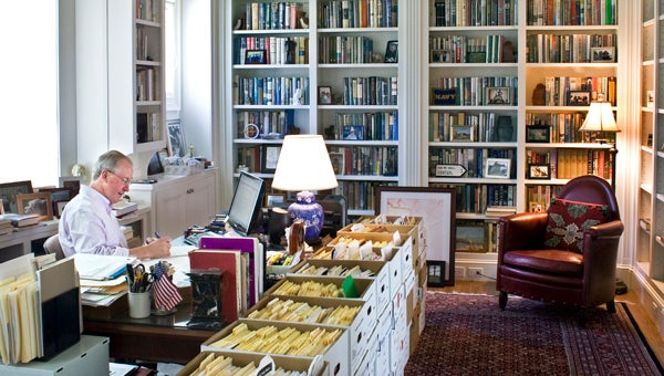 Tim Boyce in his library surrounded by a few of his 4,200 first editions and the boxes of files and notes for the first edition of his own non-fiction book to be published in early 2016. (Photo by Vincent Verrecchio)