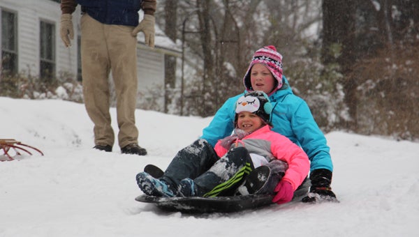 Ellen Anne Williams, 12, at the back of the sled, and Piper Graham, 9, enjoyed Friday off from school at Landrum Middle and Campobello Gramling and spent the morning sledding at Brookwood Park in Landrum. Proving the Farmer’s Almanac prediction true of a particularly cold and snowy winter, the weekend’s storm, named Winterstorm Jonas by the National Weather Service, left the Foothills area with 7.5 inches of snow starting Thursday night before making its way up the East Coast.  (Photo by Claire Sachse)