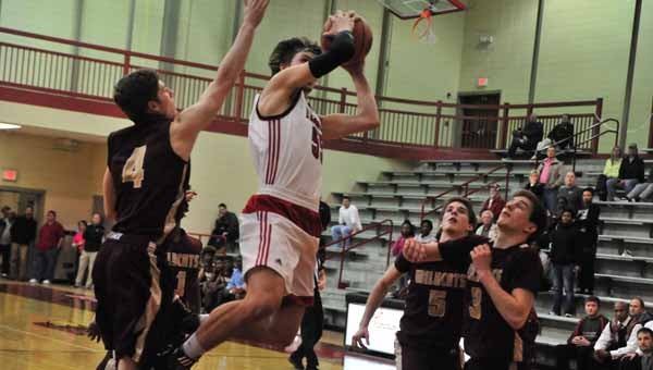 With less than 15 seconds left in the game, Landrum's Jacob Corn (with ball) drove to the hoop for two points, putting the Cardinals just two behind visiting Ninety-Six in the Feb. 17 opening round of the Upper State Playoffs. However, Ninety-Six escaped with a 59-56 win. (Photo by Mark Schmerling)