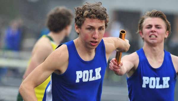 Polk County's Sean Doyle takes the baton from Jeremy Allsbrook in the 4x800-meter relay. (Photo by Mark Schmerling)