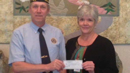 Retired Master Sergeant Bevin Corbin presents a check to Jean Eckert, CEO of Hospice of the Carolina Foothills.