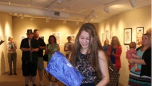 A student receives an award at the Showcase of Excellence student reception on March 12.