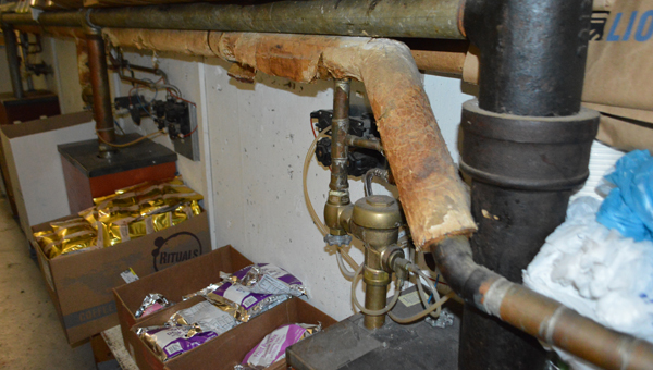 The jail's food storage, located in a narrow hallway with plumbing pipes around it. (Photos by Leah Justice)